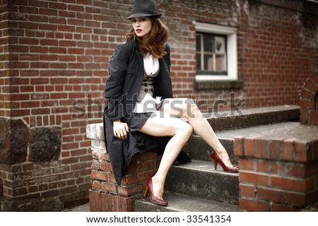 Portrait of a young and stylish woman wearing a fedora.