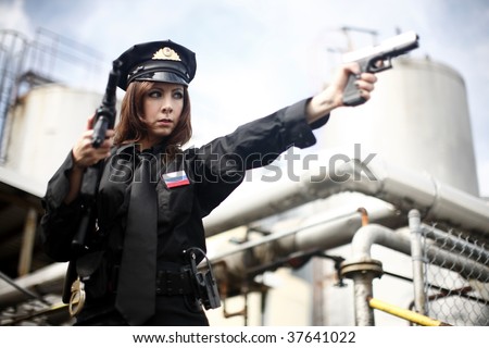Female officer pointing a gun.
