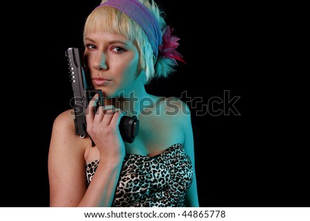 Young woman with blond hair with a pistol.