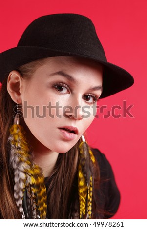 Young woman wearing a black fedora.