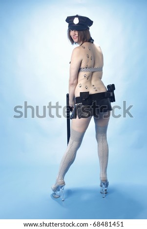 Sexy female police officer with blue background.