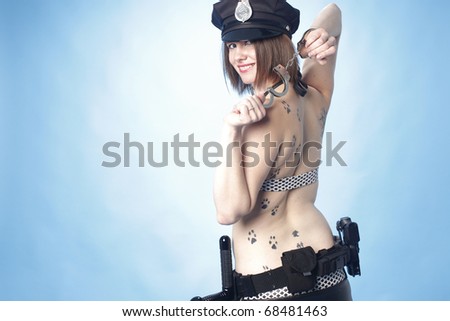 Sexy female police officer playing with handcuffs.