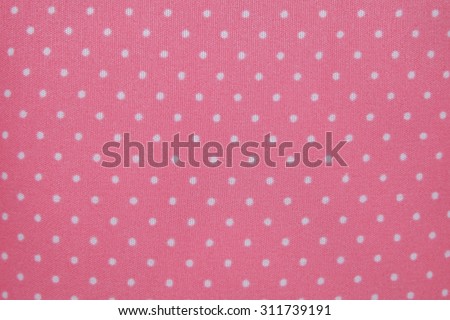 Small white polka dots on pink background fabric