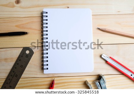 Notebook, pencil, cutter blade and ruler