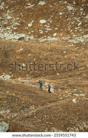 Similar – Image, Stock Photo Unrecognizable traveler walking up hill along road