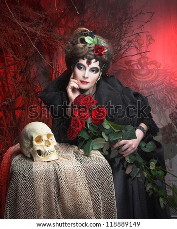 Spanish woman. Young woman in dramatic artistic image with rose's and skull