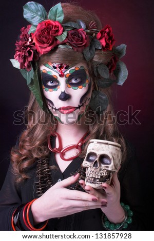 Santa Muerte. Young woman with artistic visage and with roses in her hair/