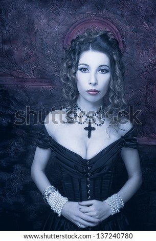 Victorian lady with bloody nimbus.Young woman in black dress and corset.