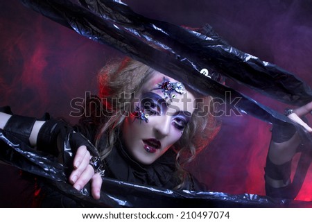 Halloween lady.. Young woman in holiday image of mystery gothic doll.