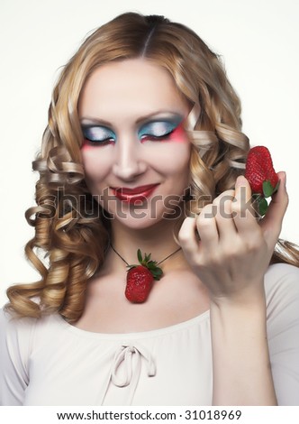Portrait of pretty blonde with fresh strawberry
