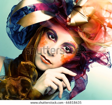 Portrait of young woman with creative make-up in doll style