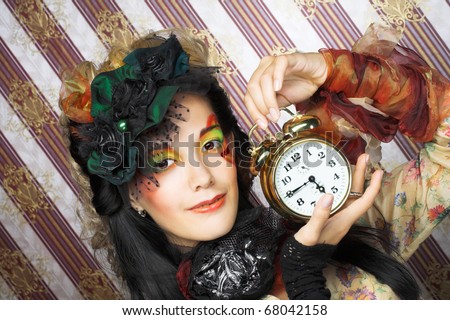 Portrait of young creative woman with clock.