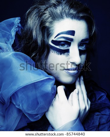 Romantic portrait of young lady with creative make-up in blue scarf