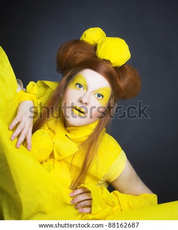 Girl in yellow. Portrait of young happy woman in artistic image.