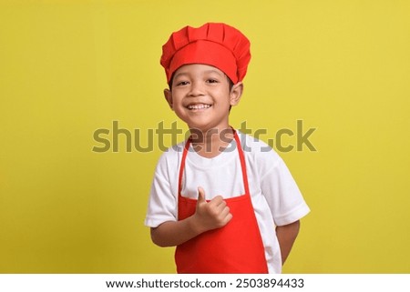 Image, Stock Photo Smiling boy in apron in kitchen