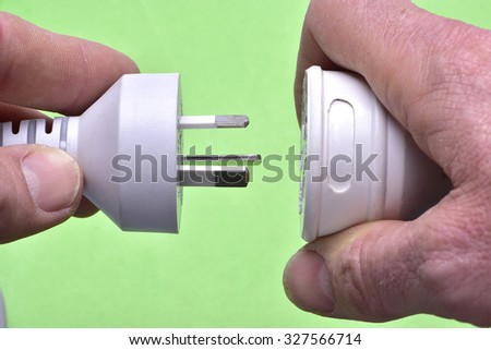 Green energy concept power cord in hand