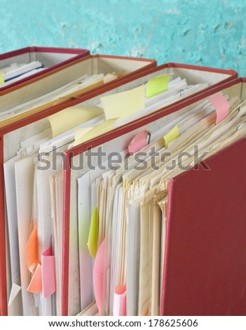 row of file folder with messy documents, selective focus