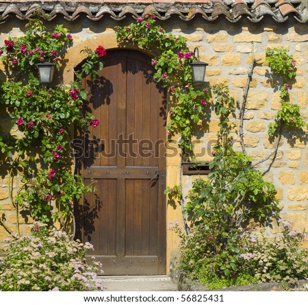 A wooden front door in the ancient stone house