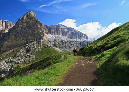 biker on high mountain road in Pordoi pass, Italian Dolomites