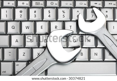 Two metal spanners on the laptop keyboard