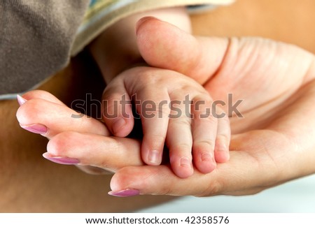 Child hand in the hand of mother