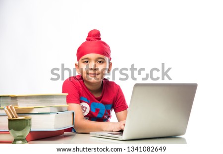 Sikh Indian kid/boy studying using laptop or playing games Stock fotó © 