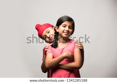 cute little sikh/punjabi boy and girl standing isolated over white background, facing camera Stock fotó © 