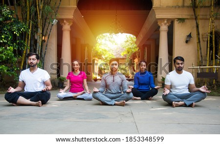 Similar – Man training yoga on beach