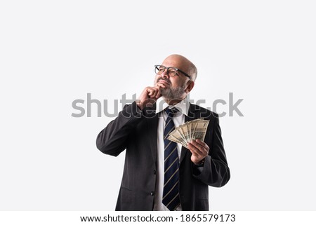 Portrait of happy Indian asian senior businessman holding indian currency notes of five hundred denominations 商業照片 © 