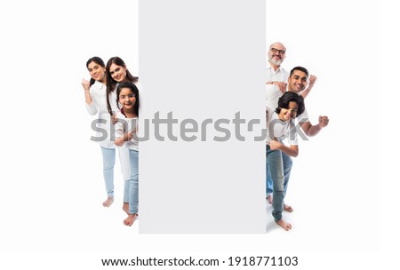 Multigenerational Indian asian family with white board, pointing or presenting empty white placard