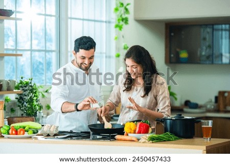 Image, Stock Photo Couple preparing food in kitchen.