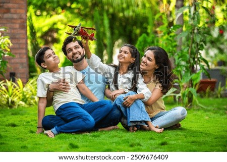 Similar – Image, Stock Photo Parents sitting with their son enjoying the time together at home