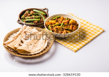 bhindi masala or bhendi masala or ladies finger fry with mixed veg in red curry with indian roti / chapati / fulka / paratha / indian bread, indian spicy food