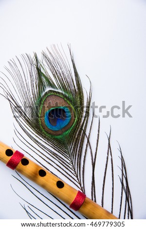free photos peacock feather and bamboo flute over colourful