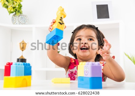 Similar – Image, Stock Photo Small girls building toy construction machine