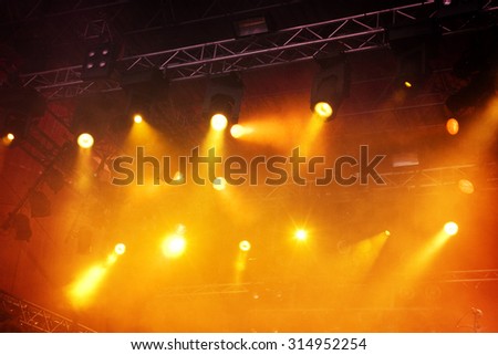 Various orange stage lights in the dark