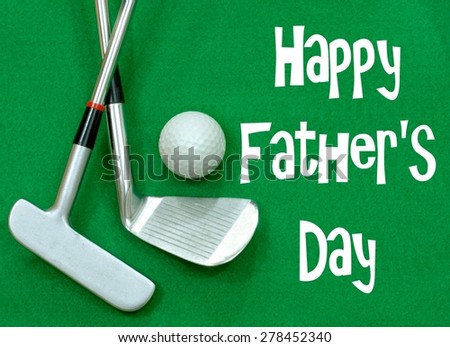 Golf clubs and golf ball on green felt background. Happy Father's Day message in white on the green felt. Clubs are a putter and a wedge, crossed, with a golf ball positioned above.  Horizontal image
