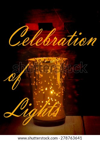 Low key image of a golden glass candle holder with many points where light can come through. Rustic wood textures below and behind the candle pick up the warm tones. Message of celebration of lights