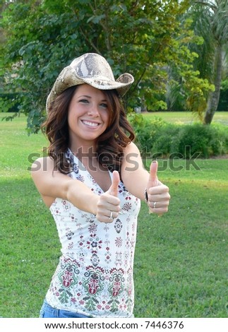Happy, upbeat, beautiful young country woman having fun outdoors
