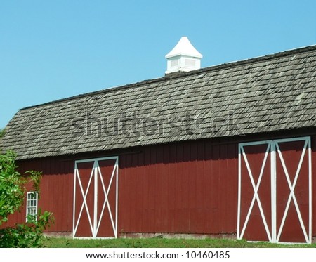 Detail of a red barn with white trim