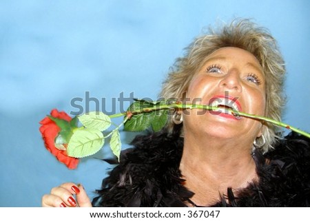 Wild woman with rose between her teeth