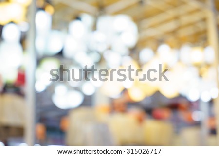 Blurry, fuzzy, soft lighting in a commercial center with several colorful lights .