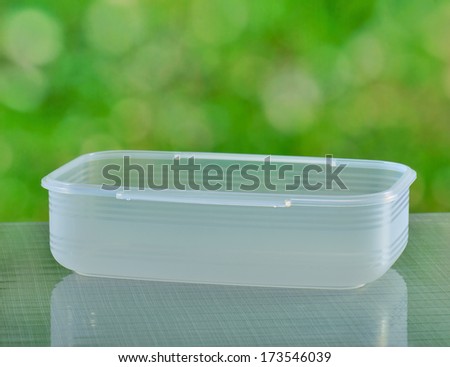 Plastic food containers on a glass tables