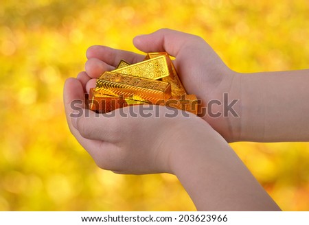 Gold ingots in hands