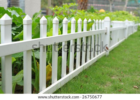 White picket fence and flower bed