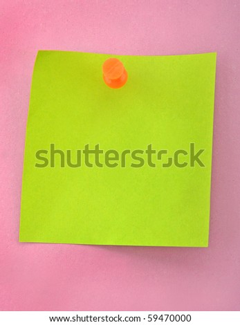 Green paper and push nail on purple background