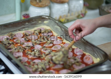 In the Polish kitchen. Preparing a delicious Home Pizza, Italian delicacy in Polish cuisine.
