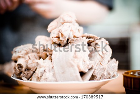 Preparation cold jelly meat based dish of pork feet, beef and turkey.