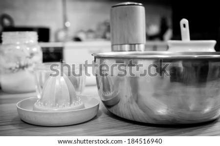 Objects in the kitchen ready to use. In the photograph: salt, cup lemon juice squeezer pepper.