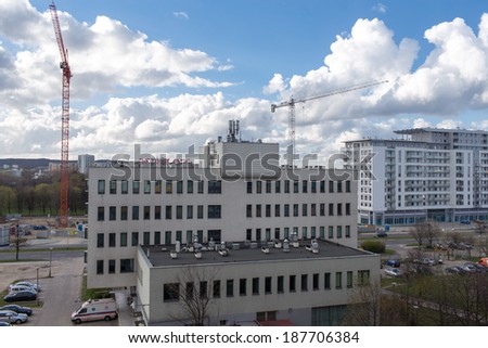 GDANSK ZASPA, POLAND - APRIL 13, 2014: Construction cranes in operation. View of the district of Gdansk-Zaspa.